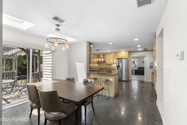 136 Sunset Rd, Lakewood, NJ 08701 - dining area featuring a skylight, a chandelier, recessed lighting, and dark tile patterned floors