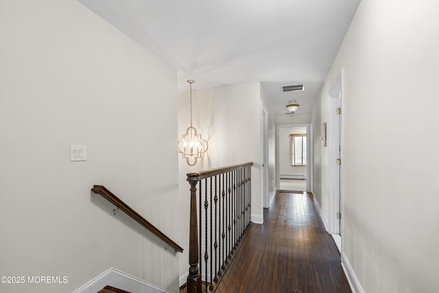 136 Sunset Rd, Lakewood, NJ 08701 - corridor with an upstairs landing, a baseboard heating unit, hardwood / wood-style floors, and a chandelier