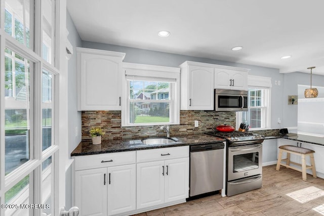 1 Cedar Ave, Rumson, NJ 07760 - kitchen featuring appliances with stainless steel finishes, dark stone countertops, white cabinets, and recessed lighting