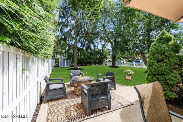 1 Cedar Ave, Rumson, NJ 07760 - fenced backyard featuring a storage shed, a patio area, and a fire pit
