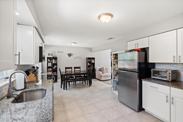 482 Radovan Ave, Bayville, NJ 08721 - kitchen featuring freestanding refrigerator, tasteful backsplash, white cabinetry, and stone counters