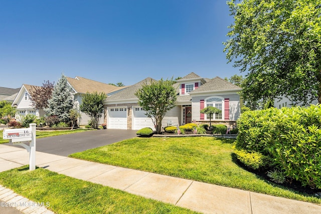 16 Gladstone St, Forked River, NJ 08731 - traditional-style home with driveway, an attached garage, and a front lawn