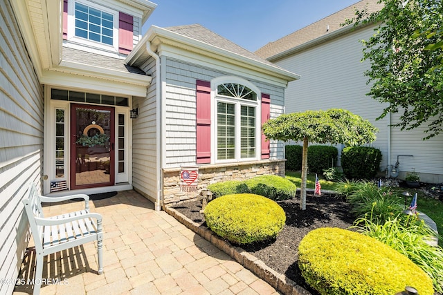 16 Gladstone St, Forked River, NJ 08731 - view of exterior entry featuring roof with shingles and stone siding