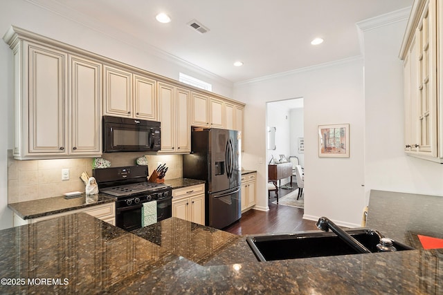 16 Gladstone St, Forked River, NJ 08731 - kitchen with black appliances, cream cabinets, dark wood-type flooring, decorative backsplash, and dark stone countertops