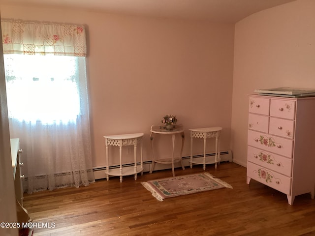 109 Edinburgh Ct, Toms River, NJ 08757 - misc room with wood finished floors and a baseboard heating unit