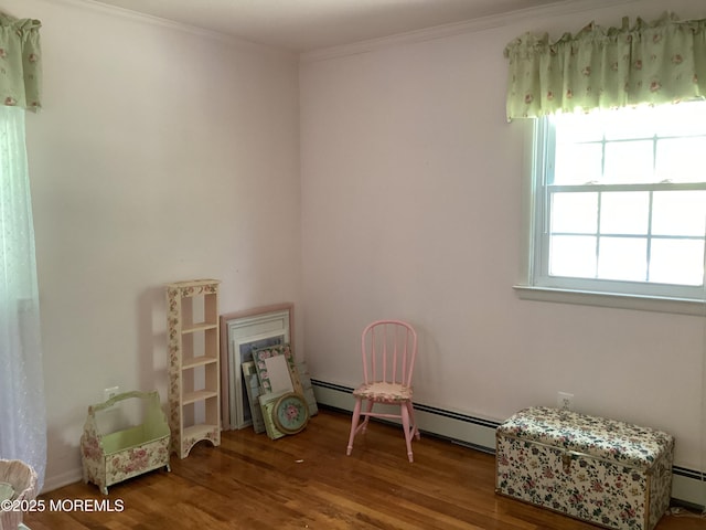 109 Edinburgh Ct, Toms River, NJ 08757 - living area featuring wood finished floors, a baseboard heating unit, and ornamental molding