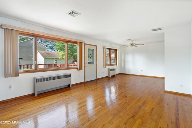 2238 Emerald Park Dr, Forked River, NJ 08731 - empty room with radiator, wood finished floors, and a ceiling fan