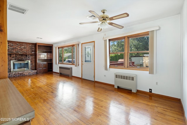 2238 Emerald Park Dr, Forked River, NJ 08731 - unfurnished living room with radiator heating unit, ceiling fan, and wood finished floors
