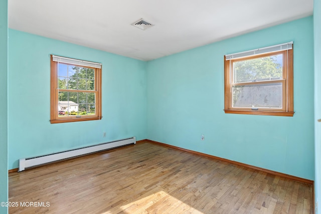 2238 Emerald Park Dr, Forked River, NJ 08731 - spare room featuring baseboard heating and wood finished floors