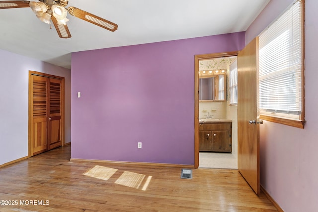 2238 Emerald Park Dr, Forked River, NJ 08731 - unfurnished bedroom with light wood finished floors, connected bathroom, ceiling fan, and a closet