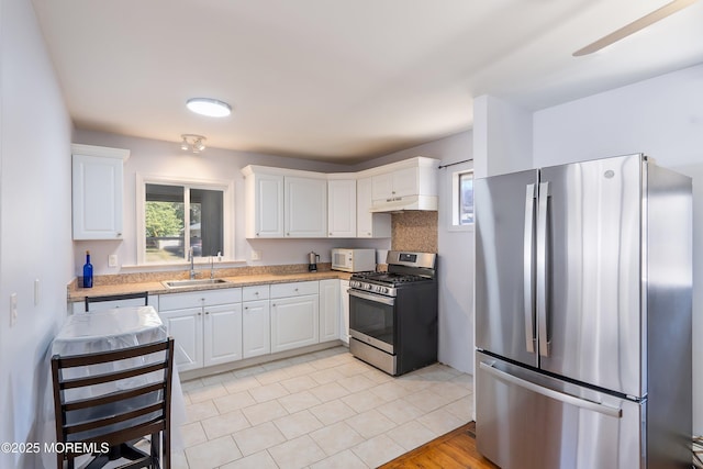 51 Berkshire Ct, Toms River, NJ 08753 - kitchen featuring appliances with stainless steel finishes, under cabinet range hood, white cabinets, and light tile patterned floors