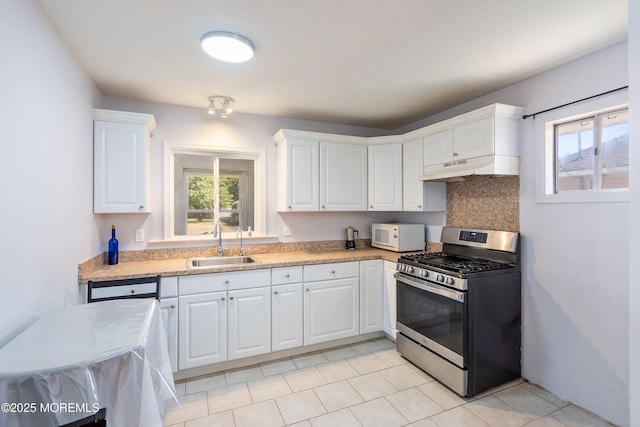 51 Berkshire Ct, Toms River, NJ 08753 - kitchen with stainless steel range with gas stovetop, white microwave, under cabinet range hood, light countertops, and white cabinetry