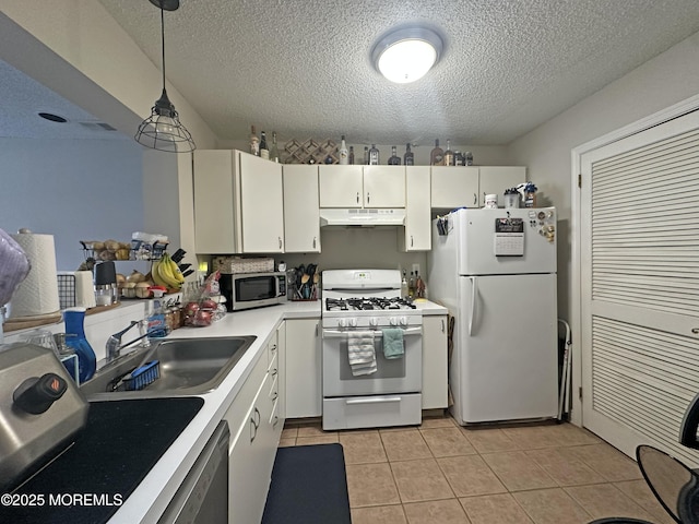 6 Madison Ct, Tinton Falls, NJ 07712 - kitchen featuring white appliances, under cabinet range hood, light countertops, a textured ceiling, and light tile patterned floors