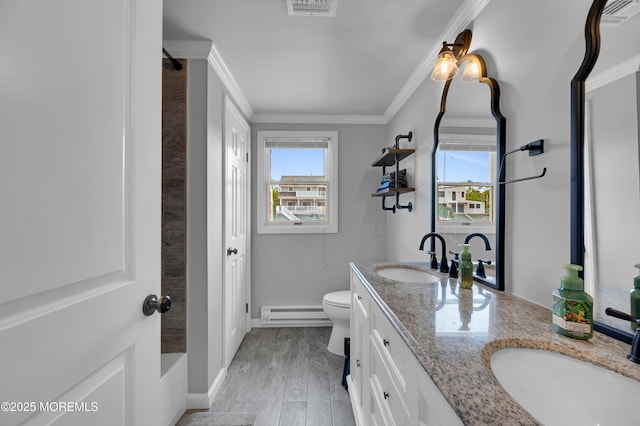 8 Navarra Dr, Brick, NJ 08723 - full bath featuring double vanity, a baseboard heating unit, crown molding, wood finished floors, and a tub