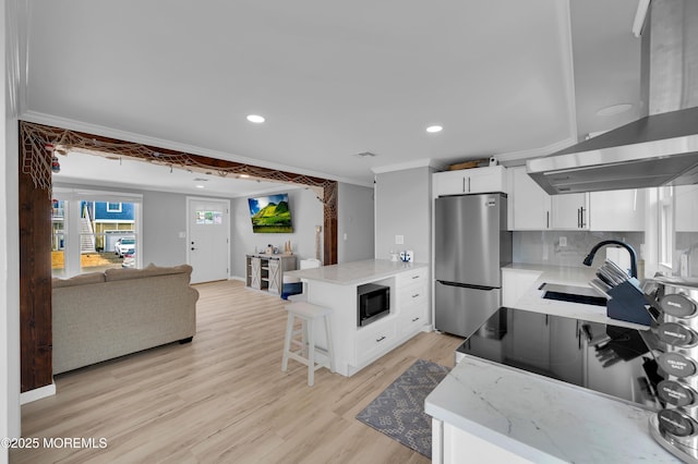 8 Navarra Dr, Brick, NJ 08723 - kitchen featuring freestanding refrigerator, wall chimney exhaust hood, black microwave, a peninsula, and light wood-style flooring