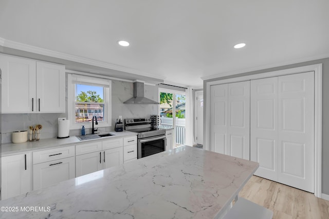 8 Navarra Dr, Brick, NJ 08723 - kitchen with stainless steel range with electric stovetop, wall chimney range hood, crown molding, tasteful backsplash, and white cabinets