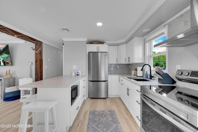 8 Navarra Dr, Brick, NJ 08723 - kitchen featuring appliances with stainless steel finishes, wall chimney range hood, a peninsula, light stone counters, and a kitchen bar