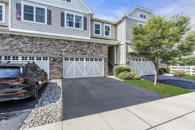 30 Malcolm Way, Lincroft, NJ 07738 - view of front of property featuring stone siding, a garage, and driveway