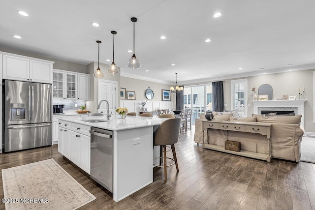30 Malcolm Way, Lincroft, NJ 07738 - kitchen with stainless steel appliances, crown molding, open floor plan, white cabinets, and a center island with sink