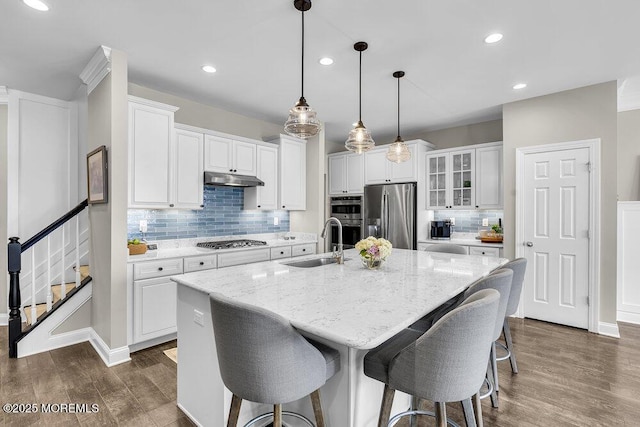 30 Malcolm Way, Lincroft, NJ 07738 - kitchen with stainless steel appliances, dark wood-style floors, under cabinet range hood, tasteful backsplash, and white cabinetry