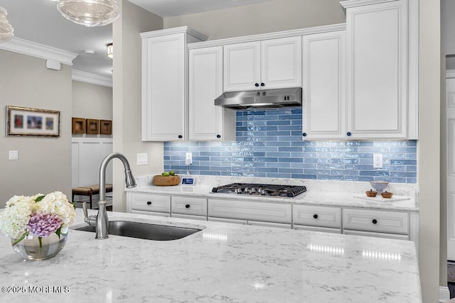 30 Malcolm Way, Lincroft, NJ 07738 - kitchen with stainless steel gas cooktop, under cabinet range hood, white cabinetry, decorative backsplash, and light stone countertops