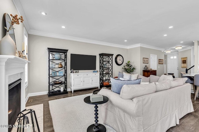 30 Malcolm Way, Lincroft, NJ 07738 - living area featuring dark wood finished floors, recessed lighting, a high end fireplace, ornamental molding, and healthy amount of natural light