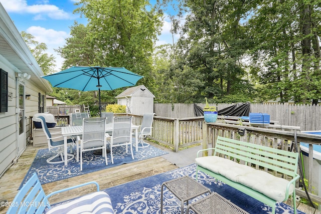 14 Cedar Ct, Manalapan, NJ 07726 - deck featuring outdoor dining area, a storage unit, and a fenced backyard