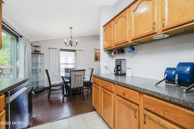 14 Cedar Ct, Manalapan, NJ 07726 - kitchen featuring dishwasher, a chandelier, dark countertops, vaulted ceiling, and light tile patterned floors