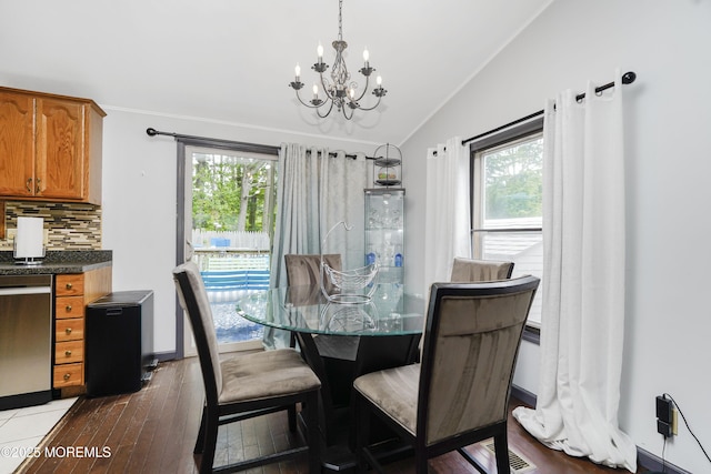 14 Cedar Ct, Manalapan, NJ 07726 - dining area featuring a chandelier, vaulted ceiling, plenty of natural light, and wood-type flooring