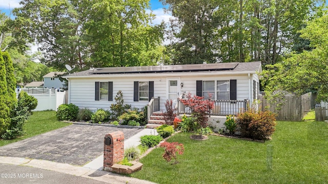 14 Cedar Ct, Manalapan, NJ 07726 - view of front facade featuring solar panels and driveway