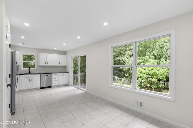 10 Postol Rd, Cream Ridge, NJ 08514 - kitchen with appliances with stainless steel finishes, white cabinetry, dark countertops, recessed lighting, and light tile patterned flooring