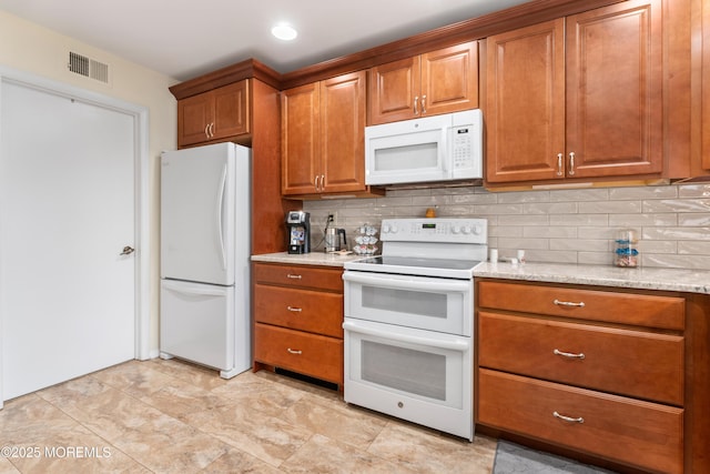 799B Westminster Ct Unit B, Manchester, NJ 08759 - kitchen featuring white appliances, brown cabinetry, tasteful backsplash, light stone countertops, and recessed lighting
