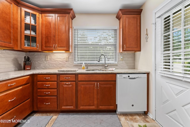 799B Westminster Ct Unit B, Manchester, NJ 08759 - kitchen with white dishwasher, tasteful backsplash, light stone counters, glass insert cabinets, and plenty of natural light