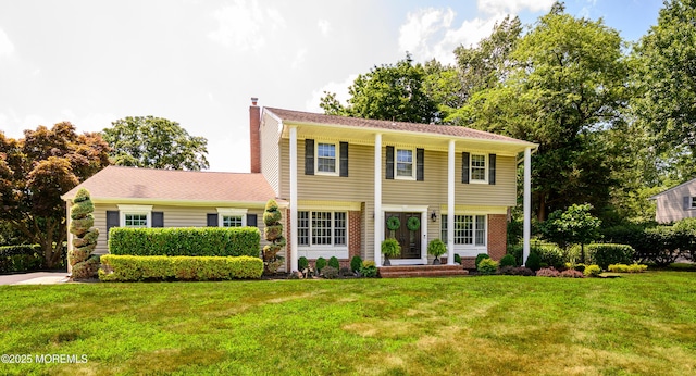 9 Partridge Ave, Freehold, NJ 07728 - view of front of house featuring a chimney, a front lawn, and brick siding