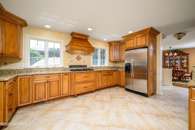 9 Partridge Ave, Freehold, NJ 07728 - kitchen featuring stainless steel fridge with ice dispenser, custom range hood, tasteful backsplash, brown cabinetry, and recessed lighting