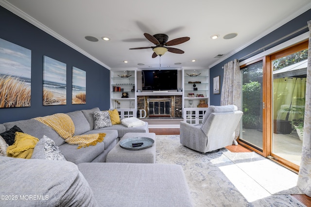9 Partridge Ave, Freehold, NJ 07728 - living room featuring crown molding, wood finished floors, a glass covered fireplace, built in shelves, and ceiling fan