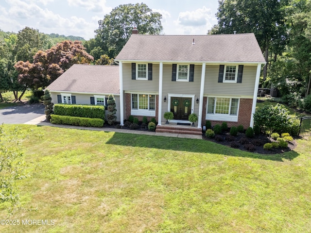 9 Partridge Ave, Freehold, NJ 07728 - view of front of home featuring french doors, a front lawn, a chimney, and brick siding