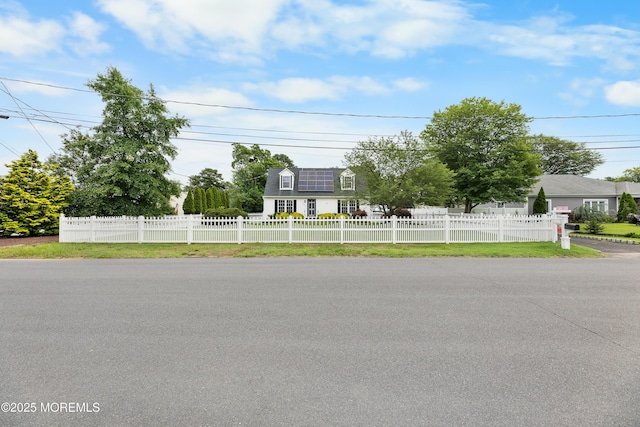 12 Liberty St, Old Bridge, NJ 08857 - new england style home with a fenced front yard and solar panels