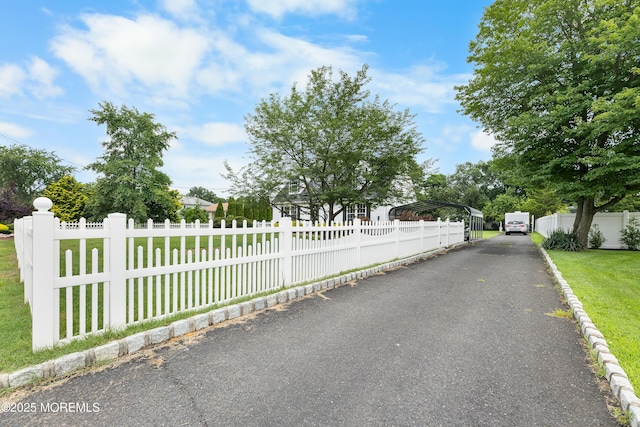12 Liberty St, Old Bridge, NJ 08857 - view of front facade with a carport, a fenced front yard, and asphalt driveway