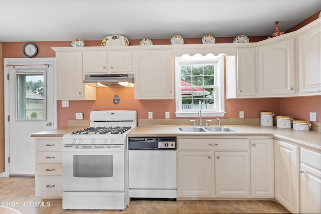 12 Liberty St, Old Bridge, NJ 08857 - kitchen featuring white appliances, under cabinet range hood, plenty of natural light, and light countertops