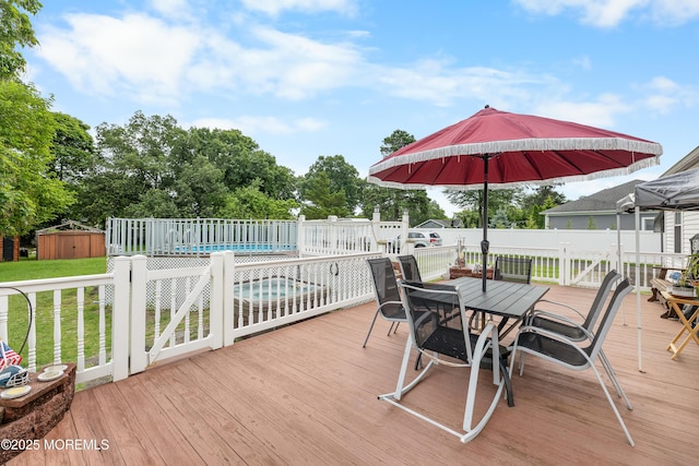 12 Liberty St, Old Bridge, NJ 08857 - wooden terrace with outdoor dining space, a yard, and a storage shed