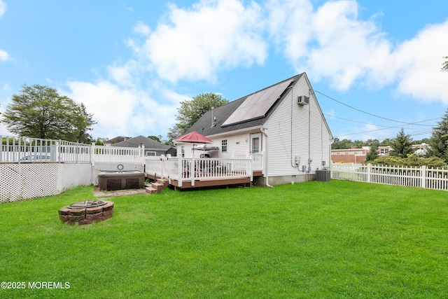 12 Liberty St, Old Bridge, NJ 08857 - back of property with an outdoor fire pit, a fenced backyard, crawl space, and a wooden deck