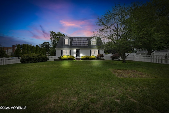 12 Liberty St, Old Bridge, NJ 08857 - view of front facade with roof mounted solar panels, a fenced backyard, and roof with shingles