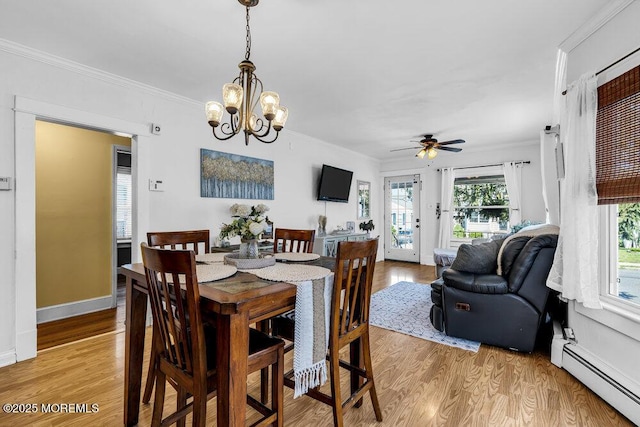 194 Washington St, Keyport, NJ 07735 - dining room with baseboard heating, light wood finished floors, crown molding, a ceiling fan, and a chandelier