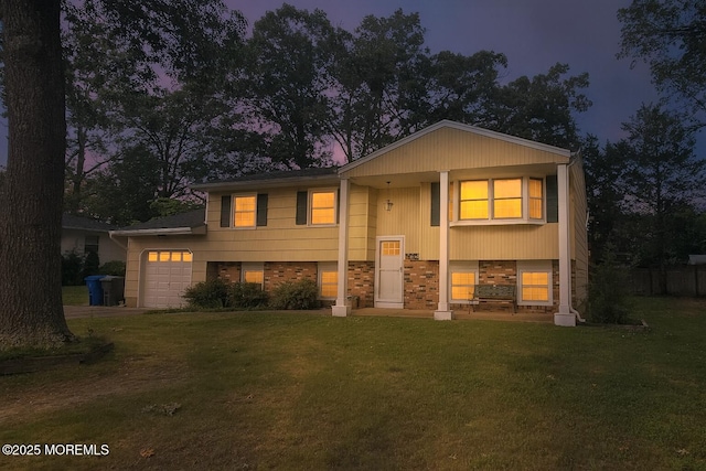 20 Woodridge Ave, Toms River, NJ 08755 - split foyer home with a garage, a front lawn, stone siding, and driveway