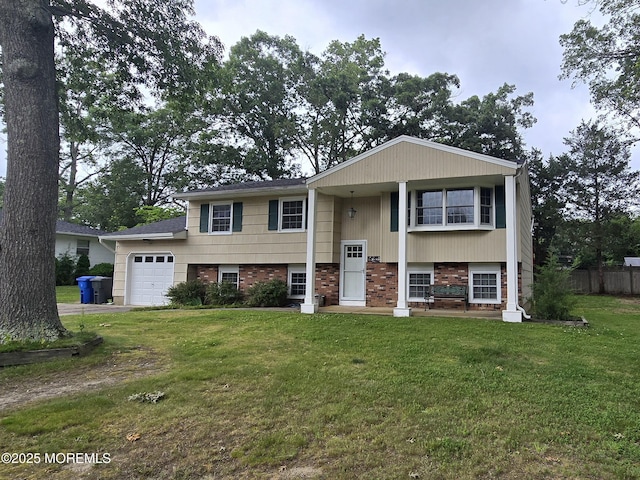 20 Woodridge Ave, Toms River, NJ 08755 - bi-level home with an attached garage, brick siding, and driveway