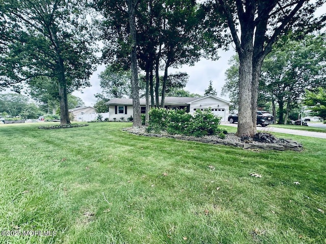 412 Steuben Ave, Forked River, NJ 08731 - view of grassy yard featuring a garage and concrete driveway