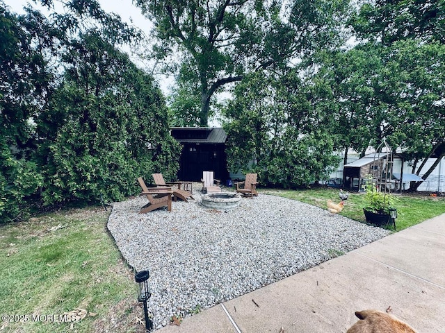 412 Steuben Ave, Forked River, NJ 08731 - view of grassy yard featuring an outdoor fire pit, an outdoor structure, and a patio