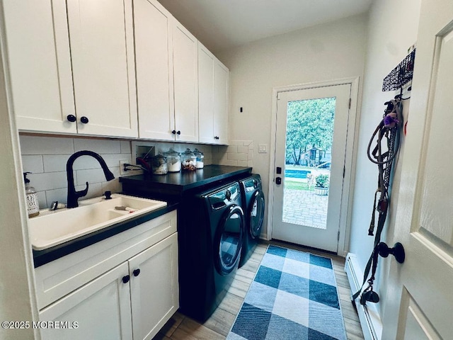 412 Steuben Ave, Forked River, NJ 08731 - laundry area featuring separate washer and dryer, cabinet space, light wood-type flooring, and a baseboard heating unit