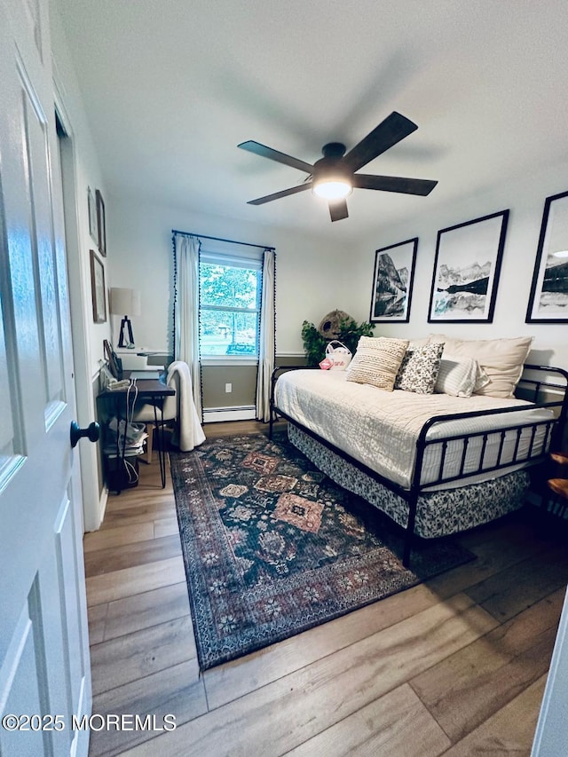 412 Steuben Ave, Forked River, NJ 08731 - bedroom with wood finished floors, baseboard heating, an office area, and ceiling fan